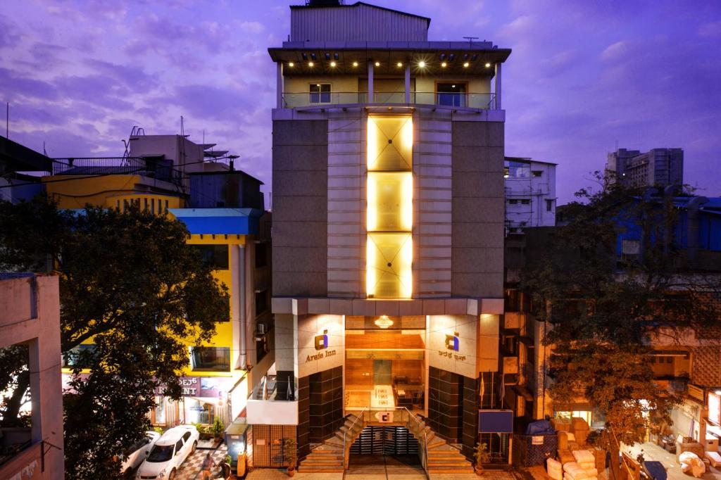 a building with a tower with lights on it at Hotel Arafa Inn in Bangalore