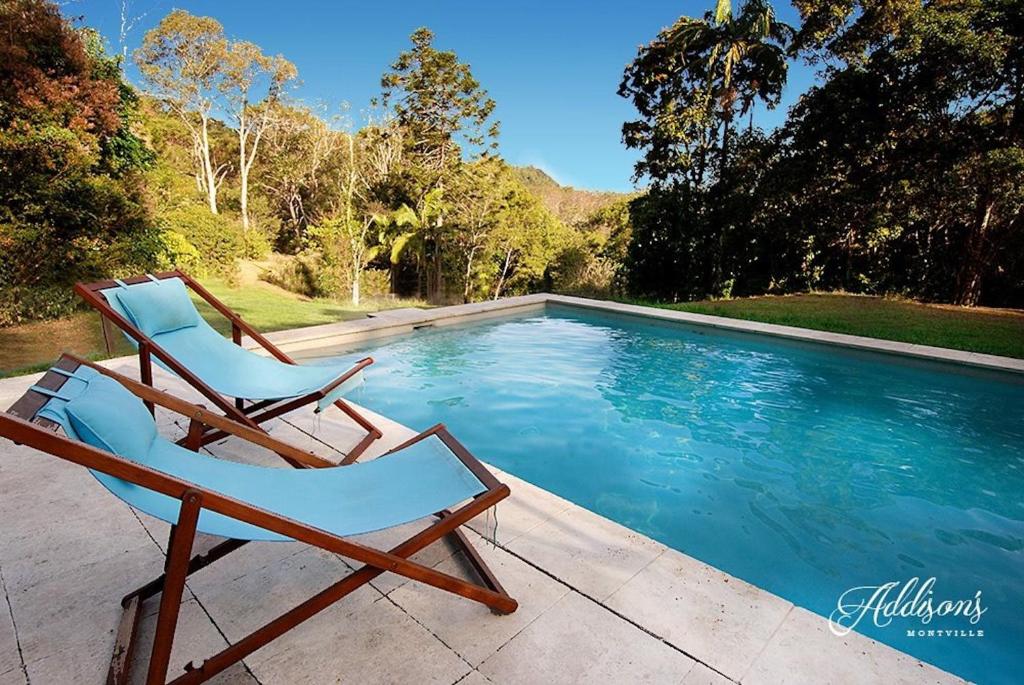 two chairs sitting next to a swimming pool at Addison's Montville in Montville