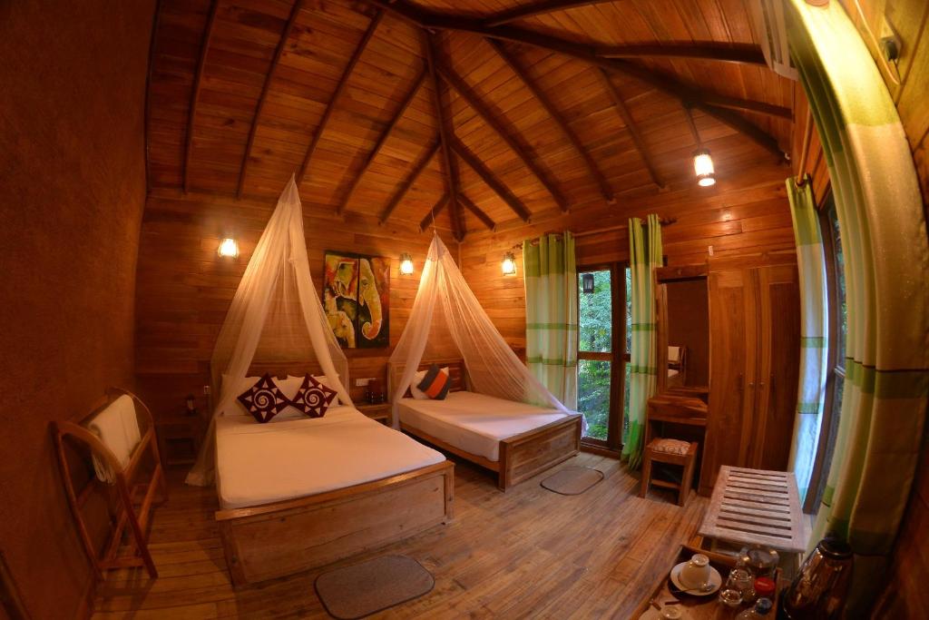 Postel nebo postele na pokoji v ubytování Habarana Tree house Mutu village