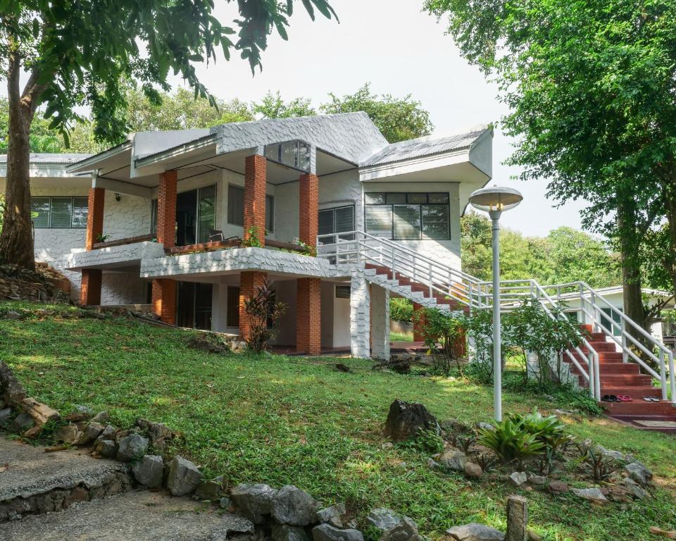 a house on a hill with a yard at The Coastal Homes -Family House With Private Beach Quite & Peaceful in Rayong