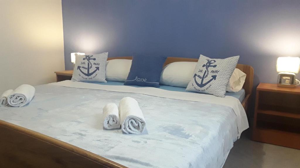 a bedroom with a bed with towels on it at VILLA AROMA in Pag