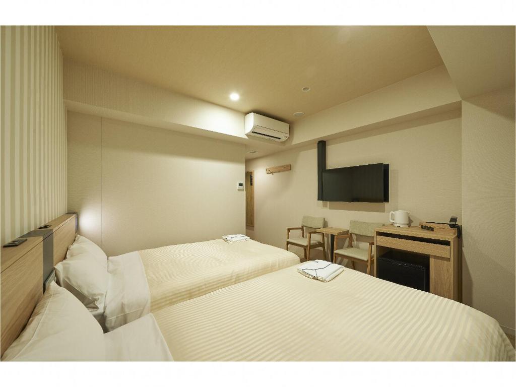 Postel nebo postele na pokoji v ubytování Sotetsu Fresa Inn Kamakura-Ofuna Higashiguchi