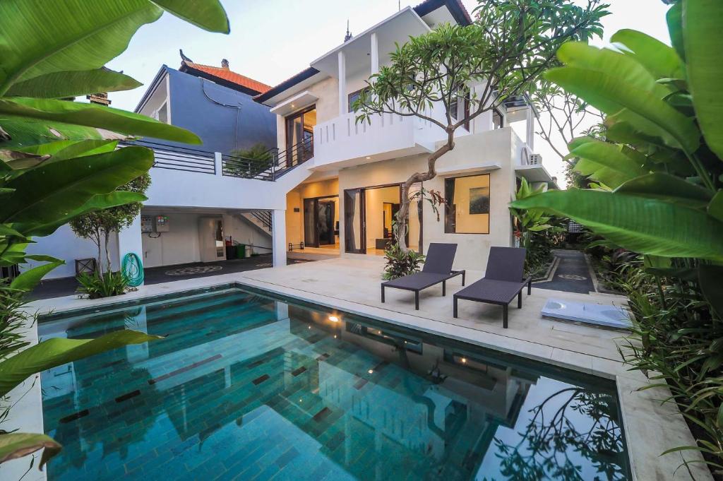 a swimming pool in the backyard of a villa at Villa Rindik Sanur in Sanur