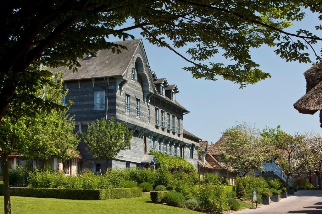 una vecchia casa con un giardino di fronte di La Ferme Saint Simeon Spa - Relais & Chateaux a Honfleur