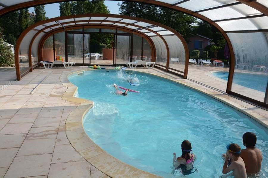 a group of people in a swimming pool at Le Hameau des Genets in Montlaur