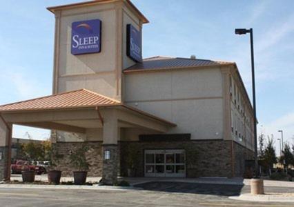 a building with a sign on top of it at Sleep Inn & Suites Garden City in Garden City