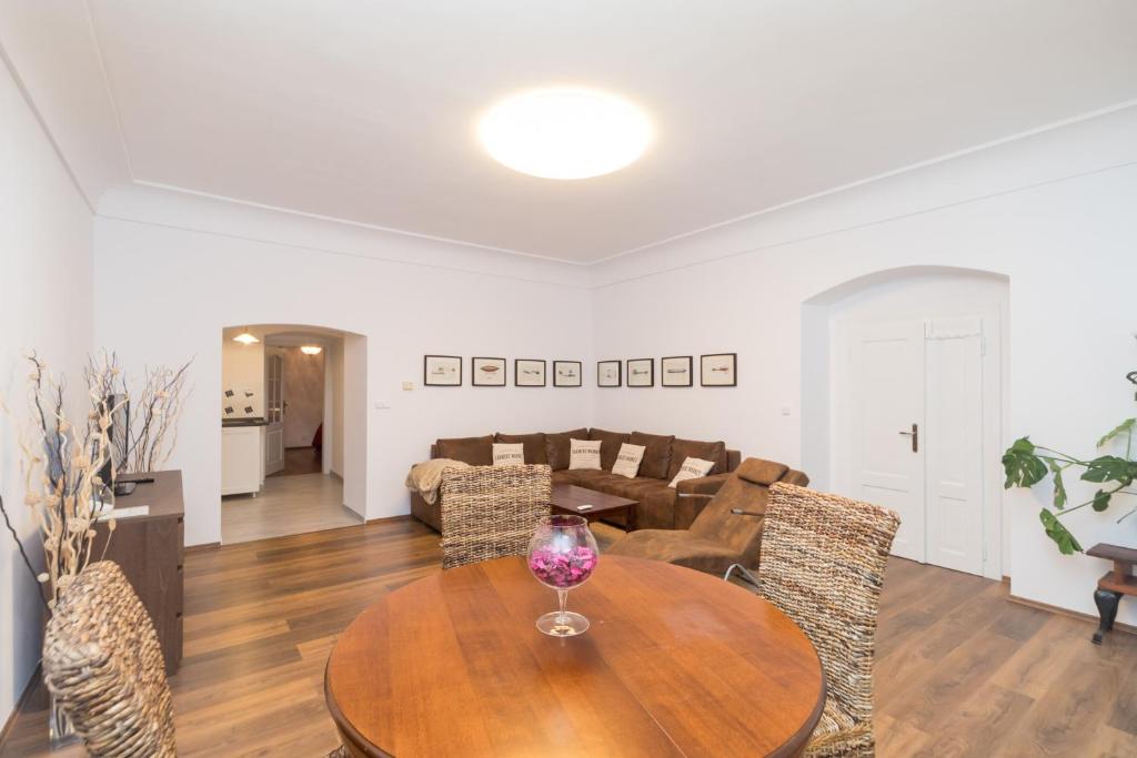 a dining room and living room with a table and chairs at Budyne Apartment II. in Budyně nad Ohří