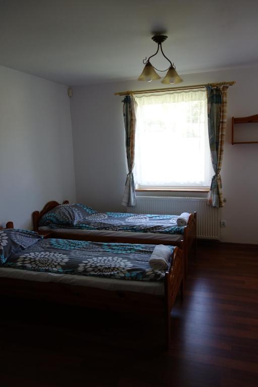 Posteľ alebo postele v izbe v ubytovaní Dom Pod Siódemką