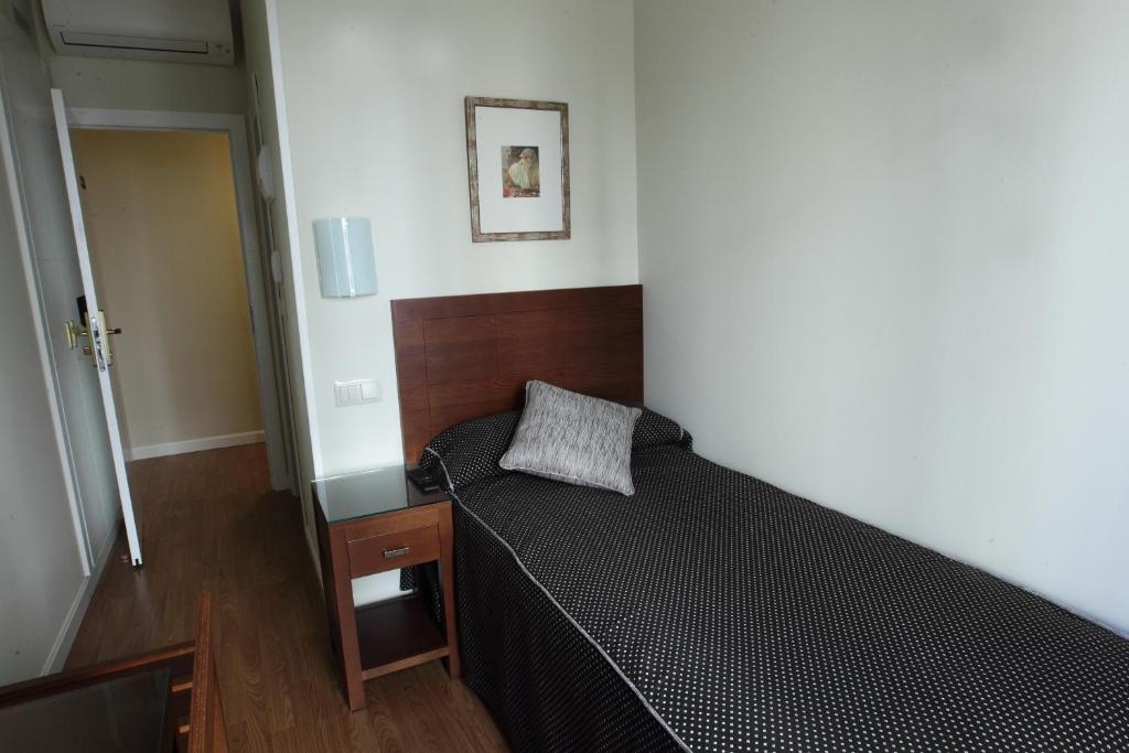 a small bedroom with a bed in a room at Rincón de Gran Vía in Madrid