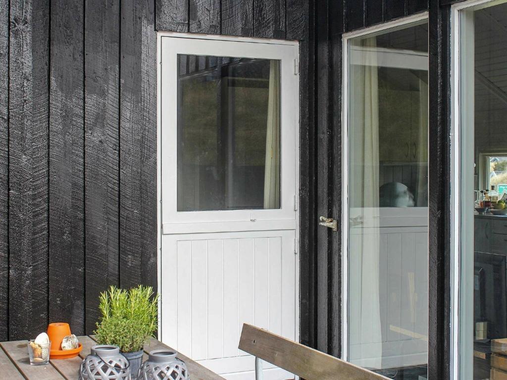 una puerta blanca en una casa con una mesa en 6 person holiday home in Vejers Strand, en Vejers Strand