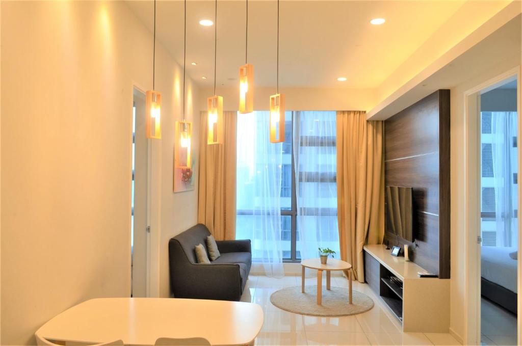 a living room with a couch and a table at The Robertson by KL MoonLight Suites Bukit Bintang in Kuala Lumpur