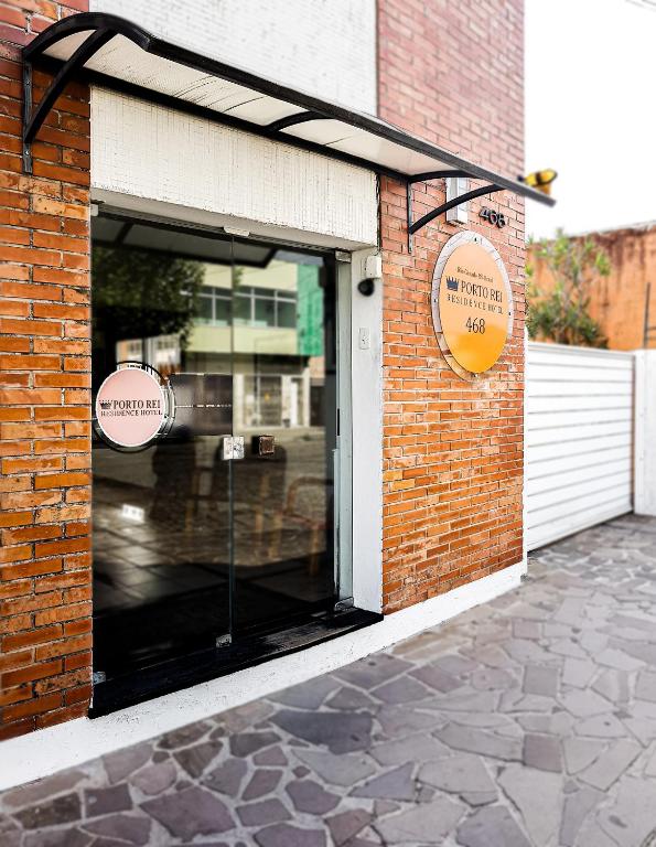 a brick building with a window on the side of it at Porto Rei Residence Hotel in Rio Grande
