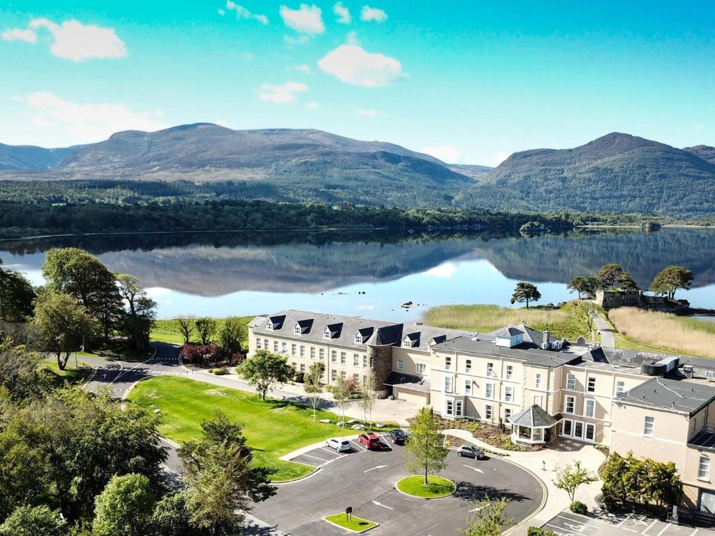 an aerial view of a resort with a lake and mountains at The Lake Hotel in Killarney