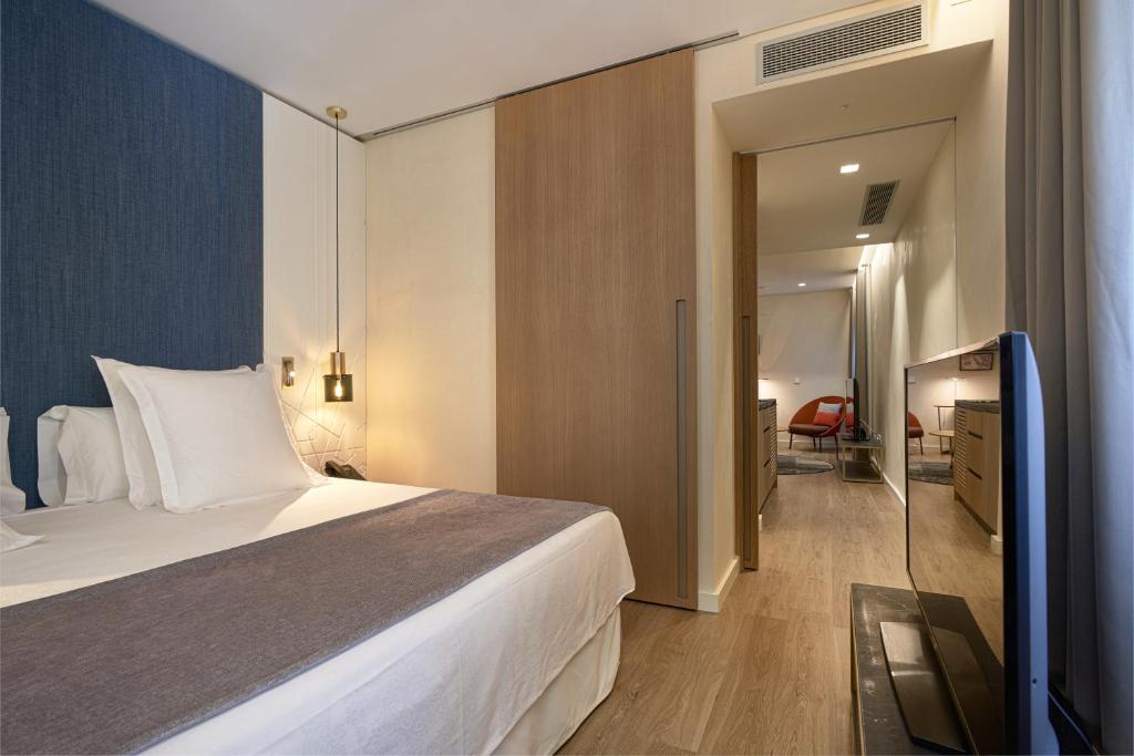 Postel nebo postele na pokoji v ubytování Suites Murillo Plaza Sta. Cruz
