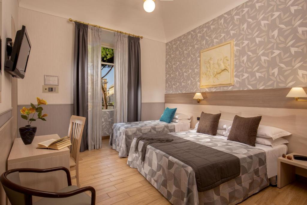 Postel nebo postele na pokoji v ubytování Hotel Dorica