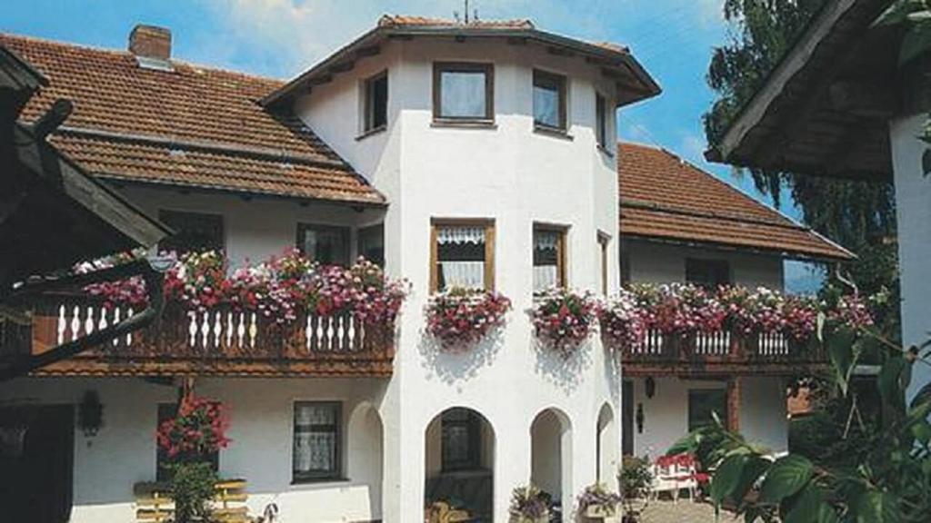 a white house with flower boxes on the side of it at Kieslinger Hilde in Arrach