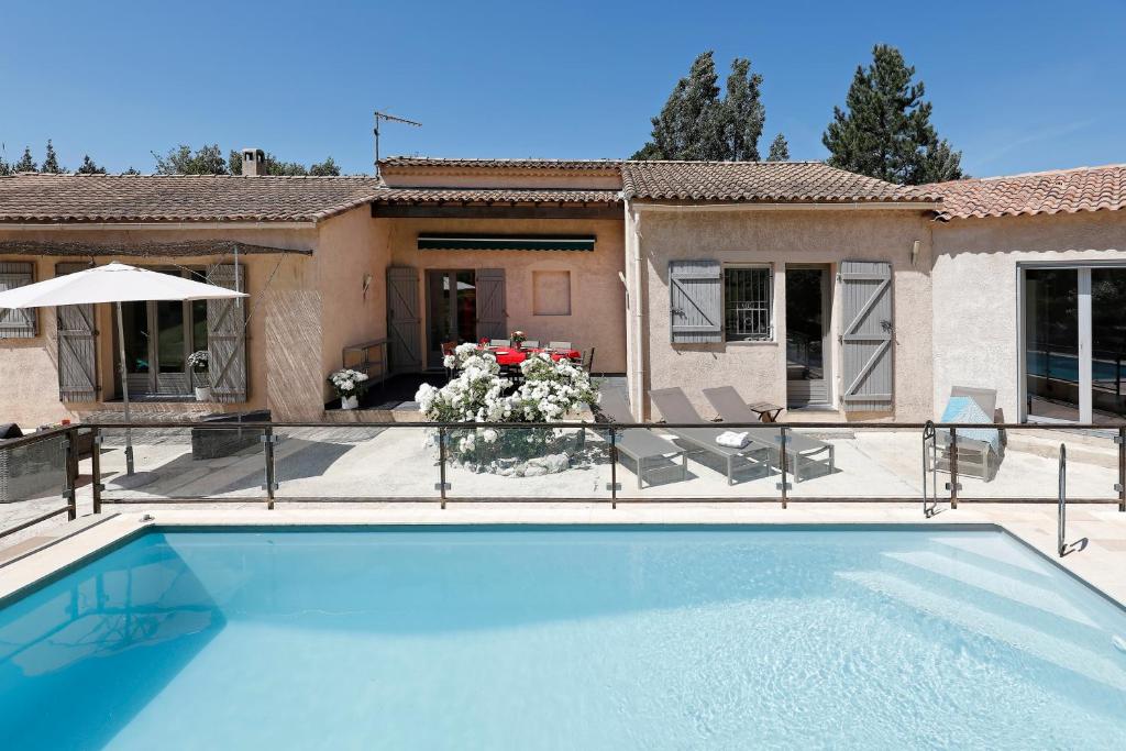 a house with a swimming pool in front of a house at Villavos- La Vassal in Cassis