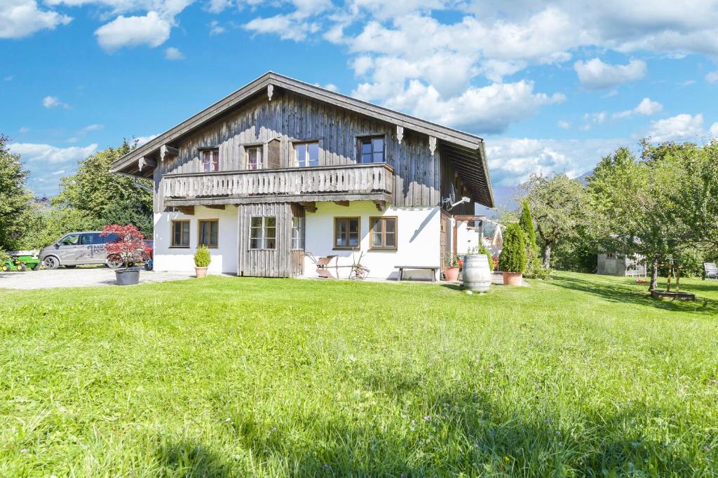 a house with a green lawn in front of it at Jaudenhof - Apartment Seekaralm in Lenggries