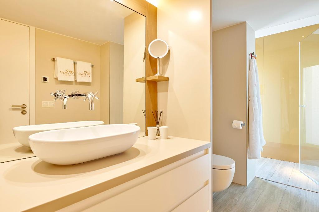 a bathroom with a large white bowl sink on a counter at 7Pines Resort Ibiza, part of Destination by Hyatt in San Jose