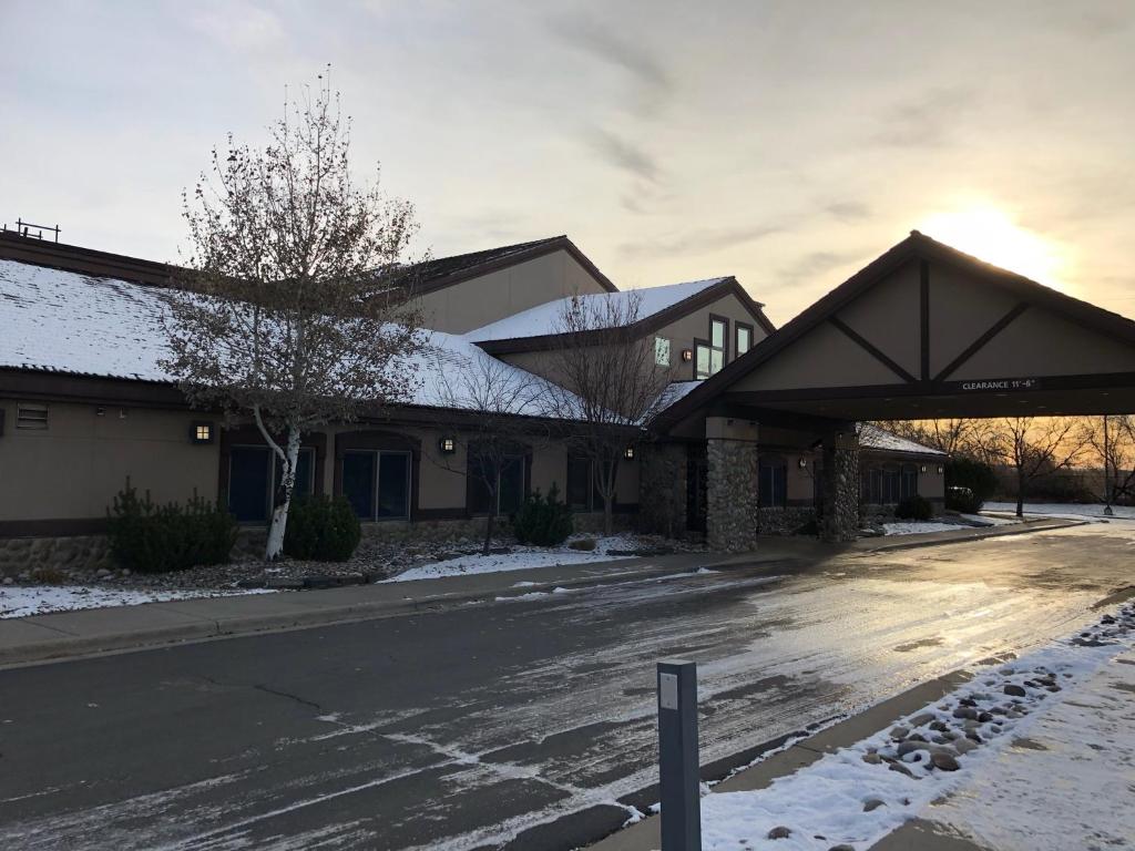 a building with snow on the side of a street at C'mon Inn Billings in Billings