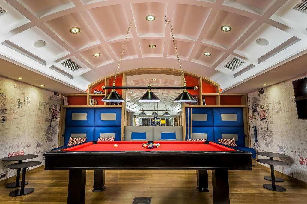 a billiard room with a red pool table at Airotel Alexandros in Athens