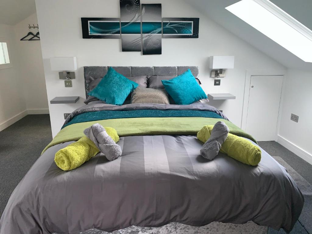 a bedroom with a large bed with stuffed animals on it at Rosemary House BRS Airport Accommodation in Bristol