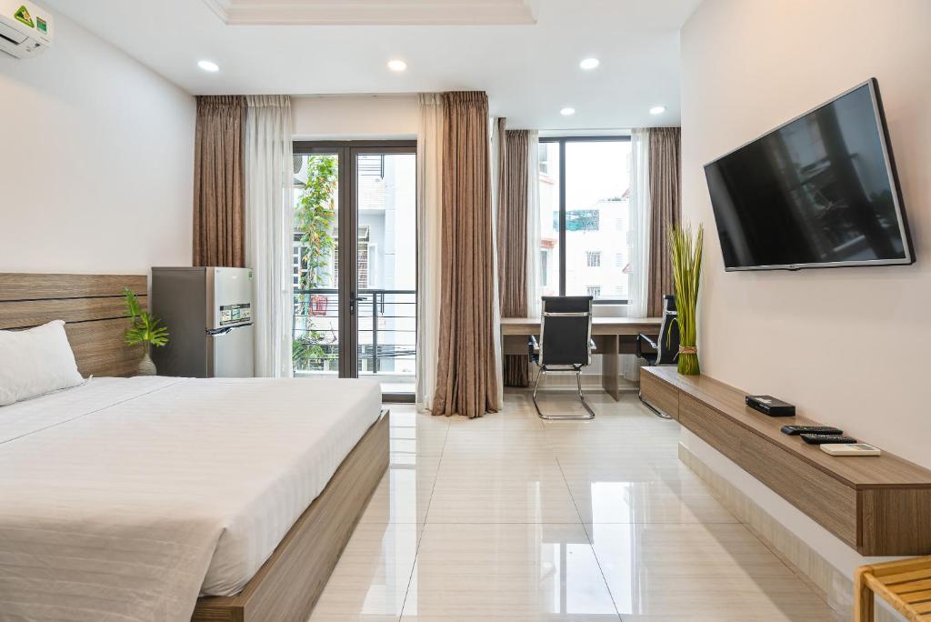 a hotel room with a large bed and a television at ViVo 416 Apartment in Ho Chi Minh City