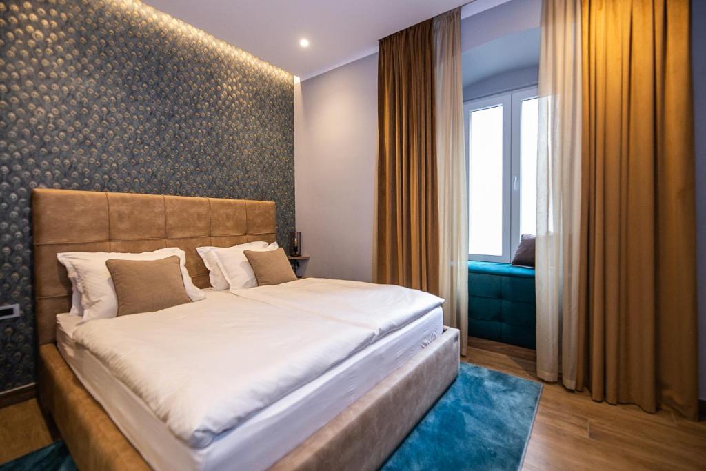 Postel nebo postele na pokoji v ubytování Teatro Suite & Rooms