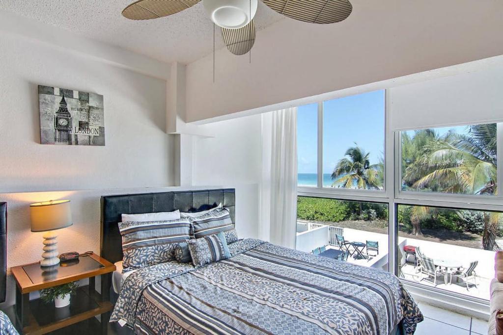 a bedroom with a bed with a view of the ocean at Oceanfront Townhouse with direct access to the Beach! Steps from the sand! in Miami Beach