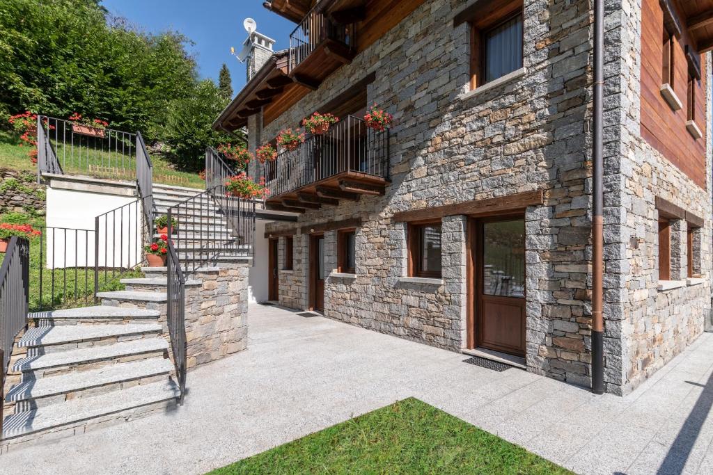 a stone building with a staircase next to a door at B&B ul calus in Crodo