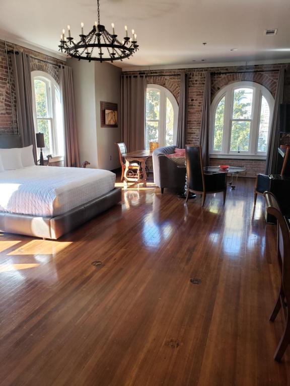 a bedroom with a large bed and a dining room at Hotel Hale in Hot Springs