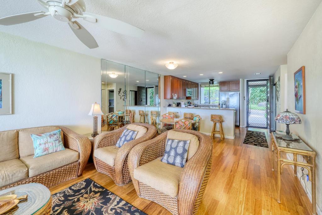 a living room with two couches and a kitchen at Country Club Villas in Kailua-Kona