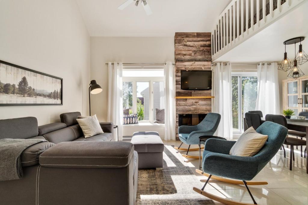 a living room with a couch and chairs at INITIAL - SYLVESTRE - Mont-Sainte-Anne in Beaupré