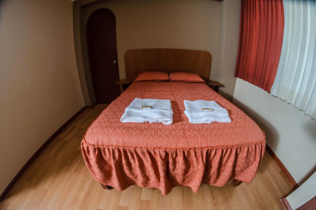 Postel nebo postele na pokoji v ubytování Hotel Arunta
