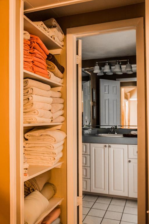 a closet with towels and a sink in a kitchen at The BoatHouse in Marco Island