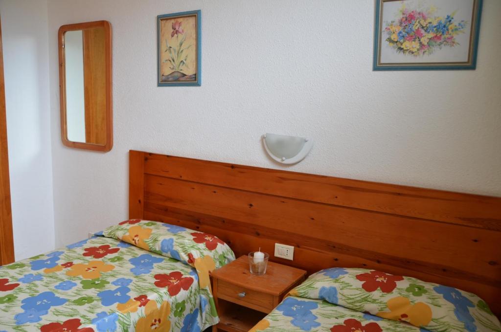 a bedroom with two beds and a mirror at Los Cactus in Playa del Ingles