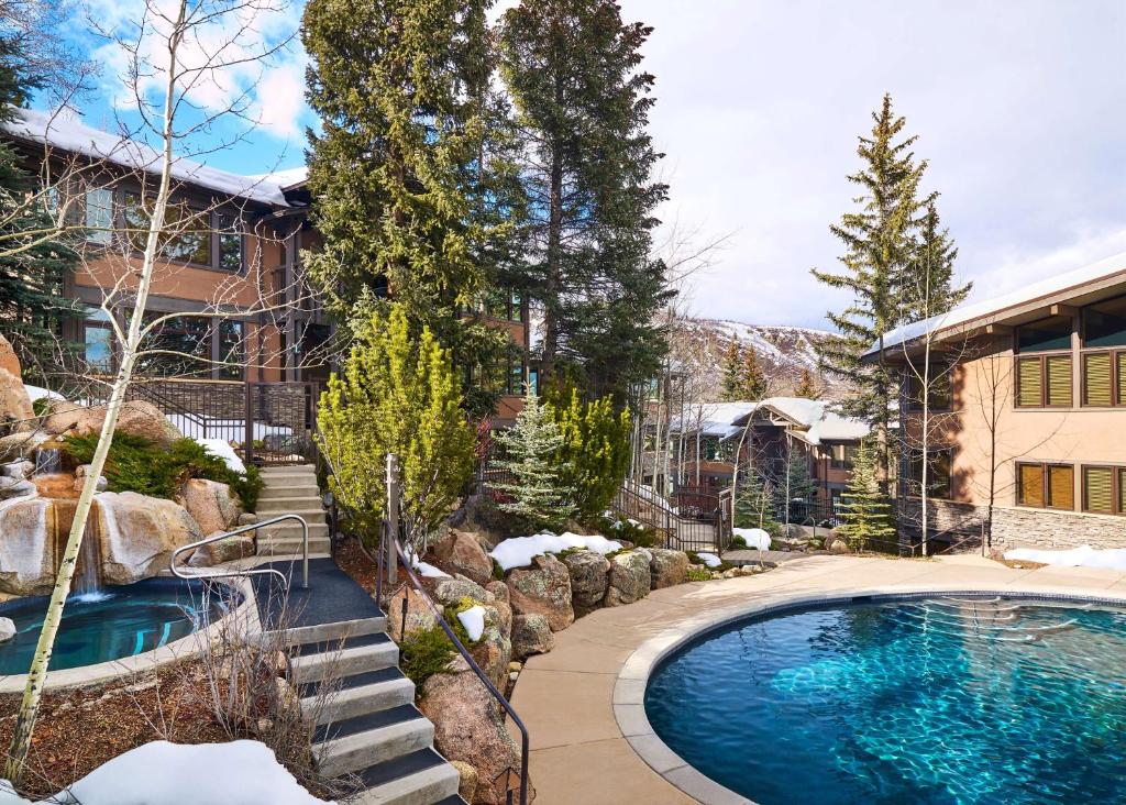 a swimming pool in the yard of a house at Aspenwood - CoralTree Residence Collection in Snowmass Village