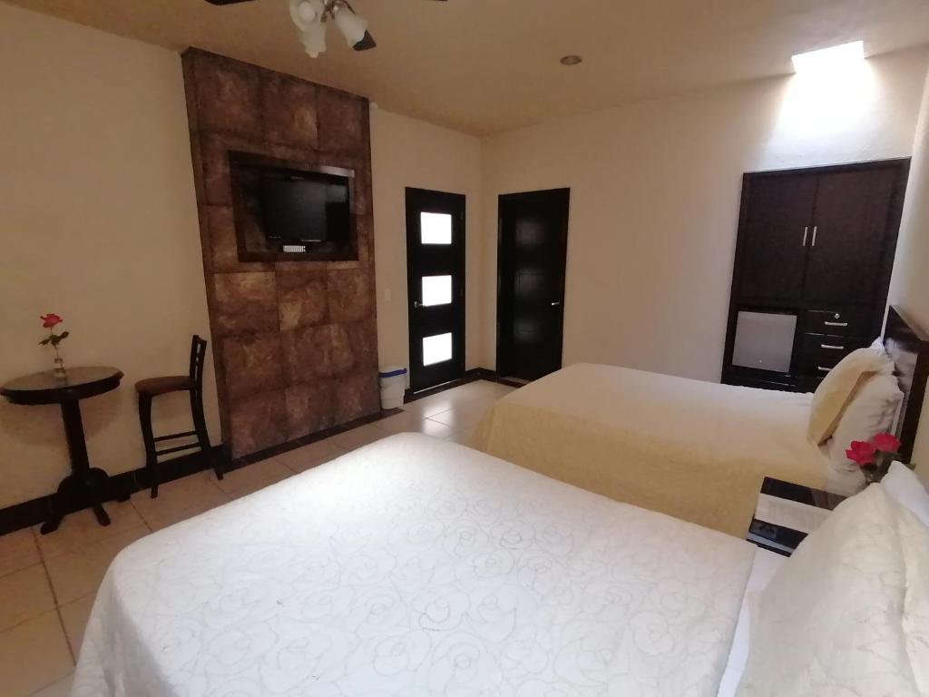Postel nebo postele na pokoji v ubytování Hotel Peña Real