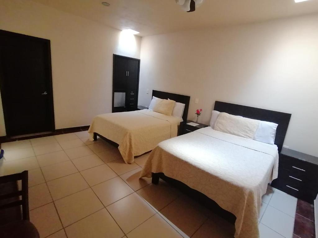 Postel nebo postele na pokoji v ubytování Hotel Peña Real