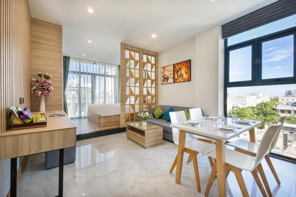 a living room with a table and a couch at Sun River Hotel & Apartment in Da Nang