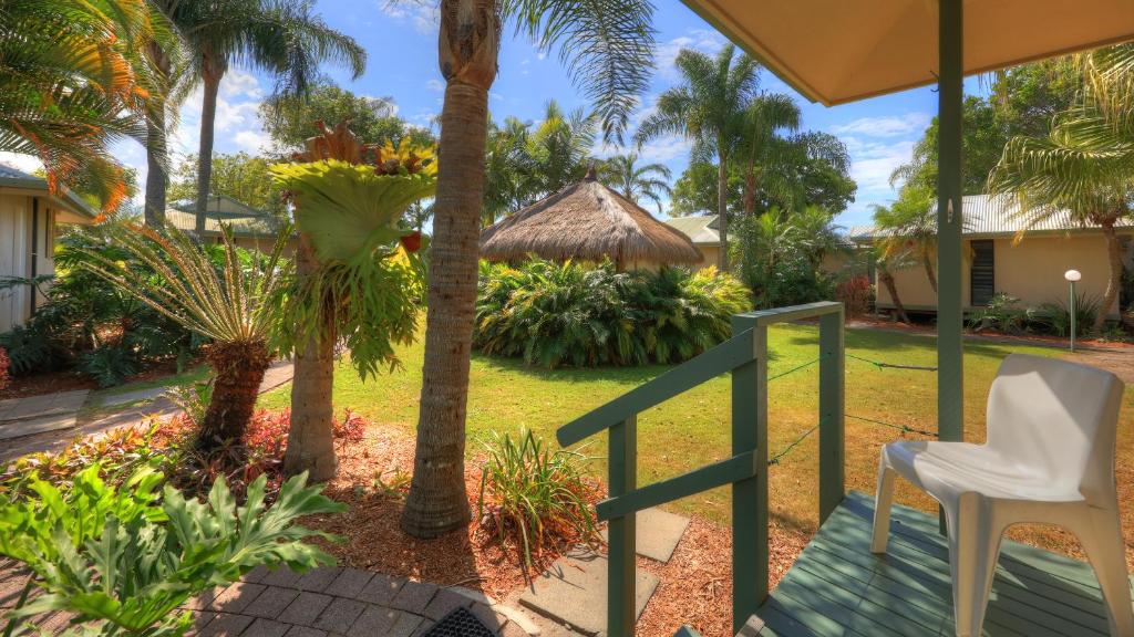 a view of a garden from the porch of a house at Maroochy River Bungalows in Diddillibah