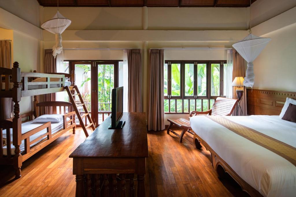 a bedroom with a bed and a desk at Royal Lanta Resort & Spa in Ko Lanta