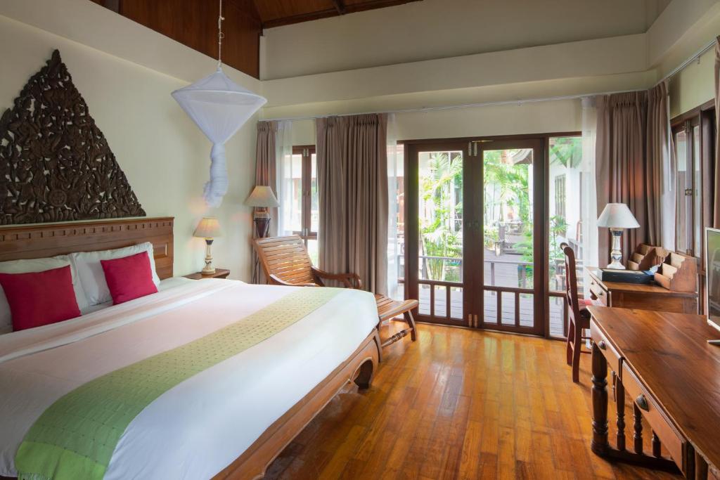 a bedroom with a large bed and a balcony at Royal Lanta Resort & Spa in Ko Lanta