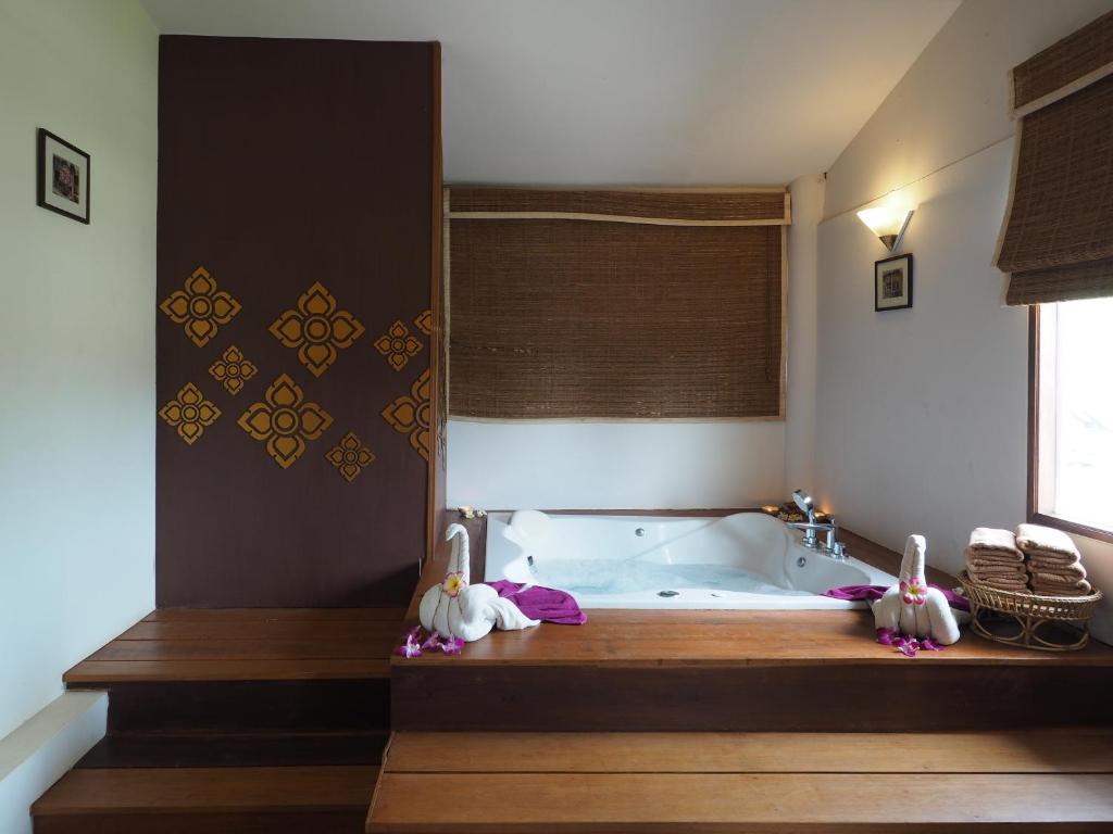 a bathroom with a bath tub in a room at Royal Lanta Resort & Spa in Ko Lanta