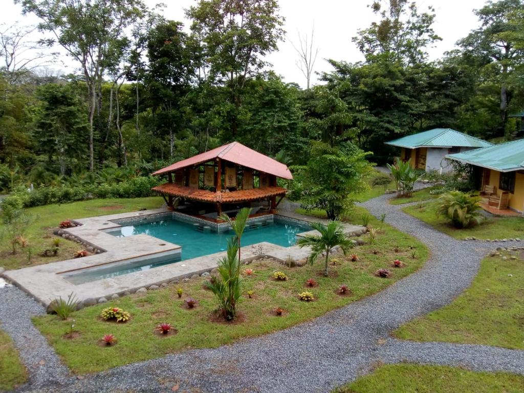 a house with a swimming pool and a pavilion at Hotel Rio Celeste Finca L´ Etoile Celeste in El Achiote