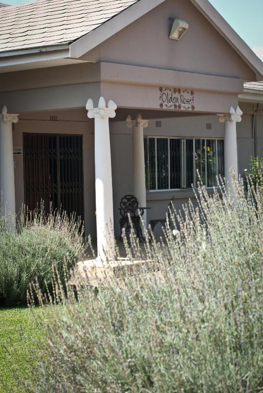 a house with a sign on the front of it at Olden Rose Place in Lephalale