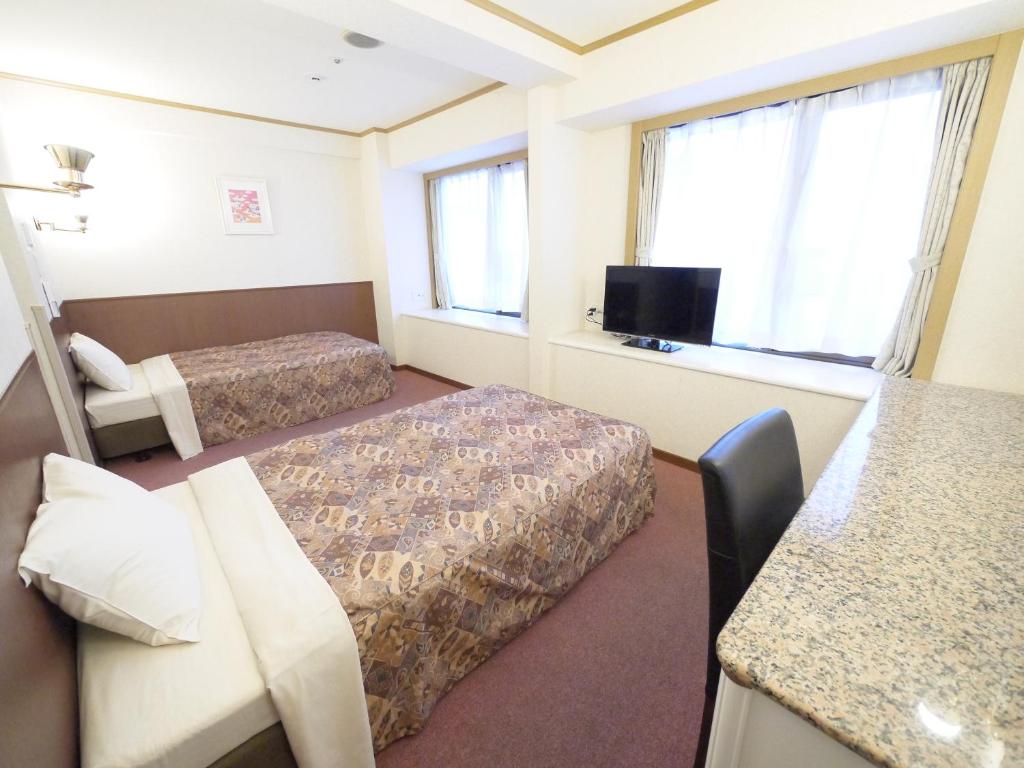 Postel nebo postele na pokoji v ubytování U-Community Hotel