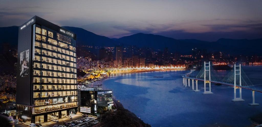 a view of a city with a river at night at Sky View Hotel in Changwon