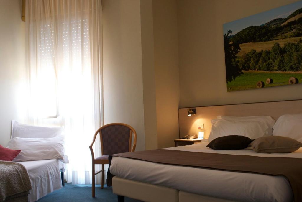 Postelja oz. postelje v sobi nastanitve Hotel Ristorante Alcide