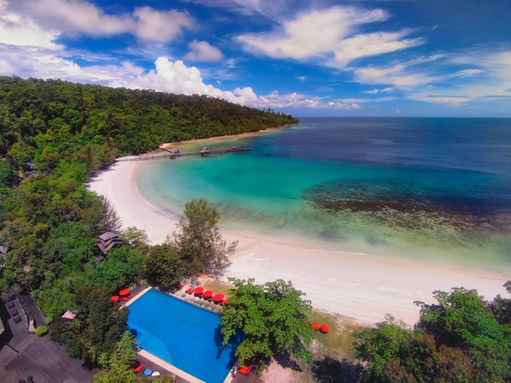 an aerial view of a beach with a swimming pool at Bunga Raya Island Resort & Spa in Gaya Island